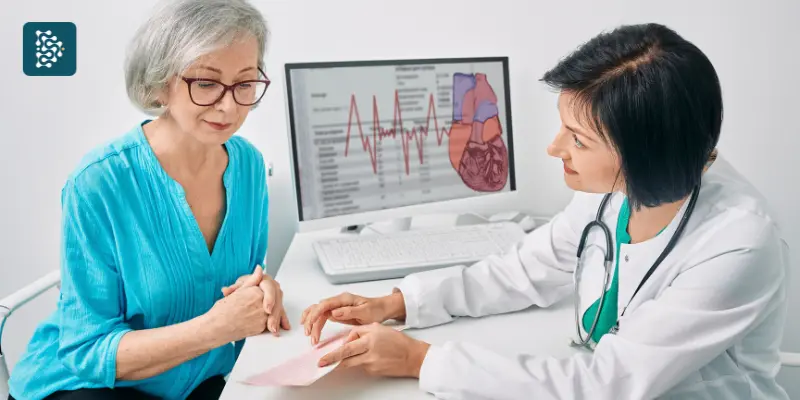 cardiologista mostrando resultado de ecocardiograma a uma paciente idosa no consultório