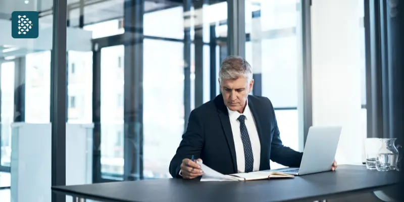 diretor do hospital olhando planilha com análise de dados financeiros